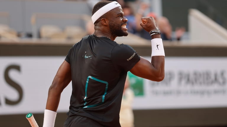 Frances Tiafoe of the U.S. clenches his fist after winning...