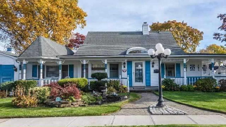 This Victorian-style house was once a standard Levittown cape. The...