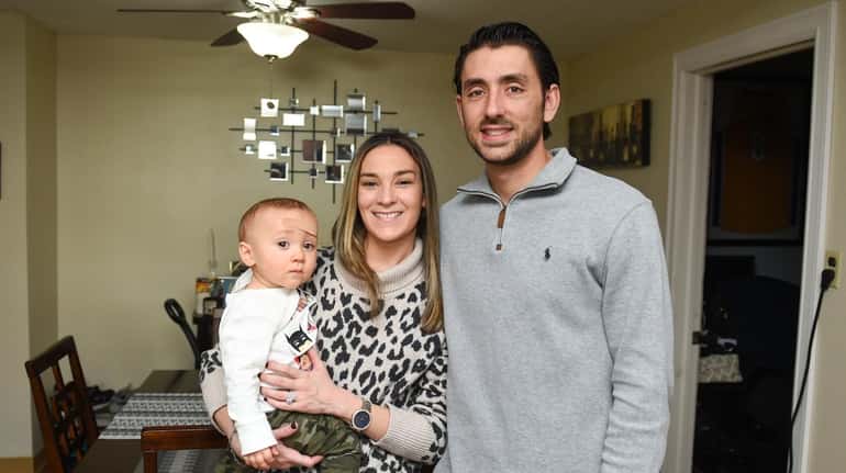 Kierstin and Jimmy Wynne with their 11-month-old baby, James, at home...