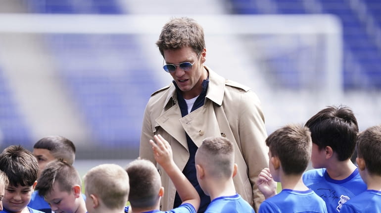 Birmingham City co-owner Tom Brady signs autographs for young fans...