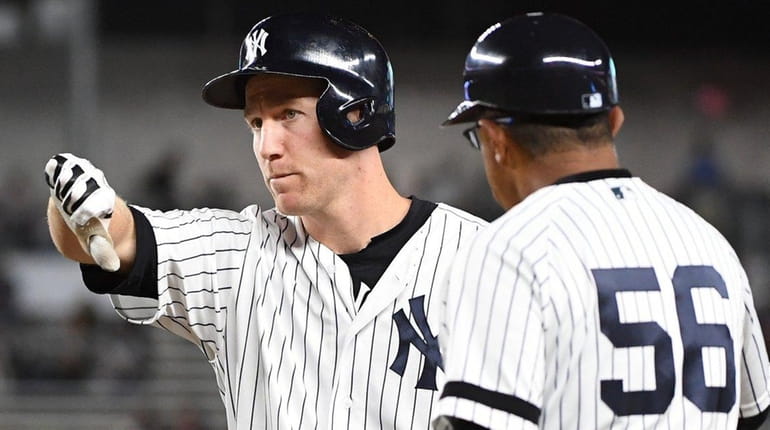 Yankees third baseman Todd Frazier gives a thumbs down to...