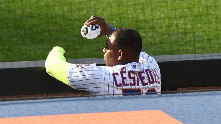 Mets' Yoenis Cespedes watches from the dugout against the Atlanta...