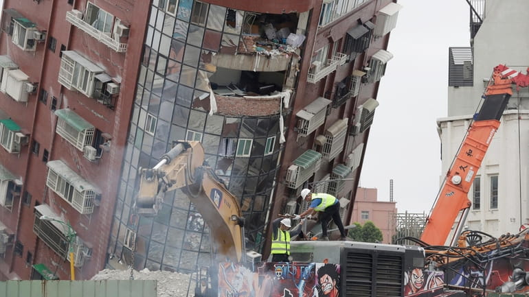 Workers begin demolition of collapsed building in Hualien City, eastern Taiwan,...