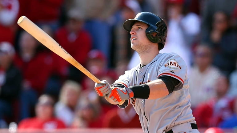 Buster Posey of the San Francisco Giants hits a grand...