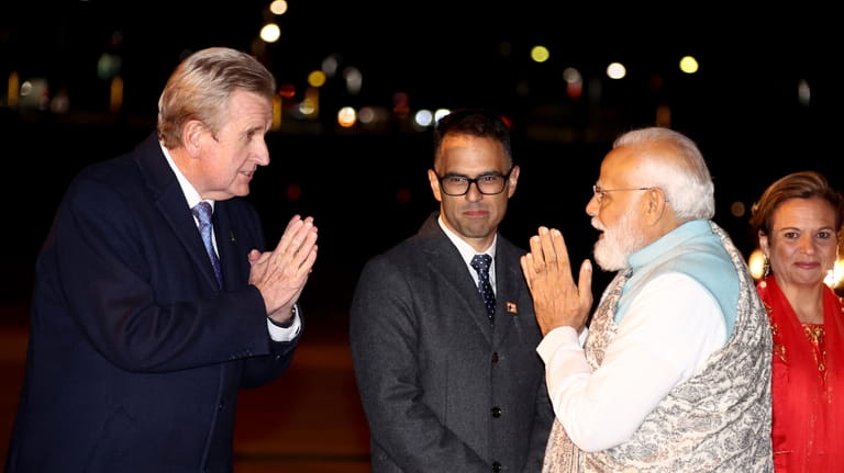India's Prime Minister Narendra Modi, right, gestures as he arrives...