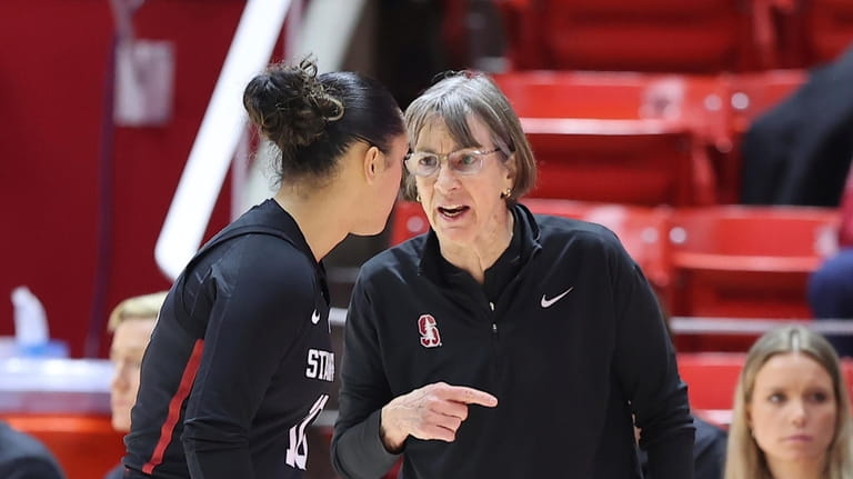 Stanford head coach Tara VanDerveer, right, speaks with Stanford guard...