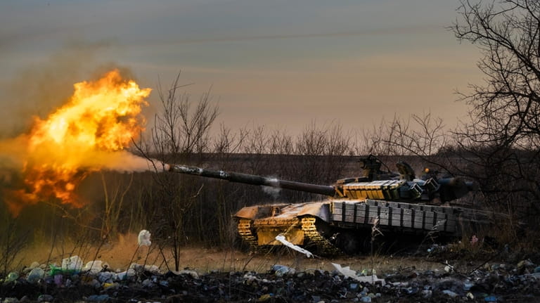 A Ukrainian tank of the 17th Tank Brigade fires at...