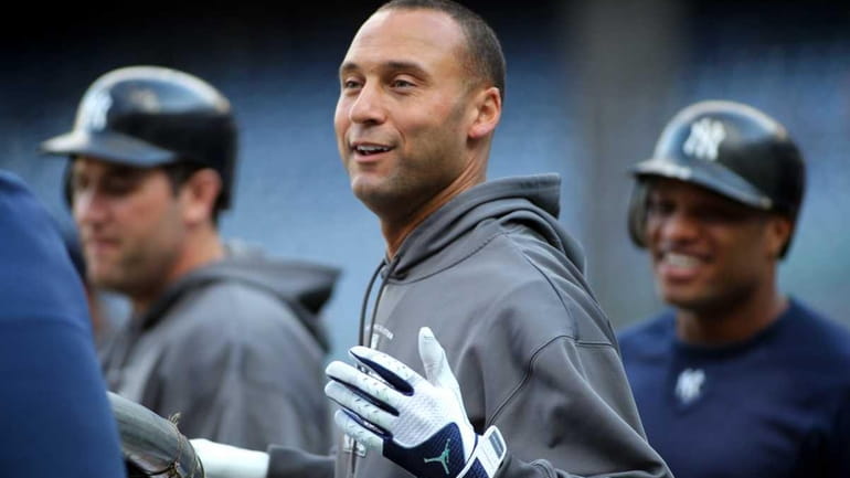 Yankees captain Derek Jeter smiles as Robinson Cano looks on....