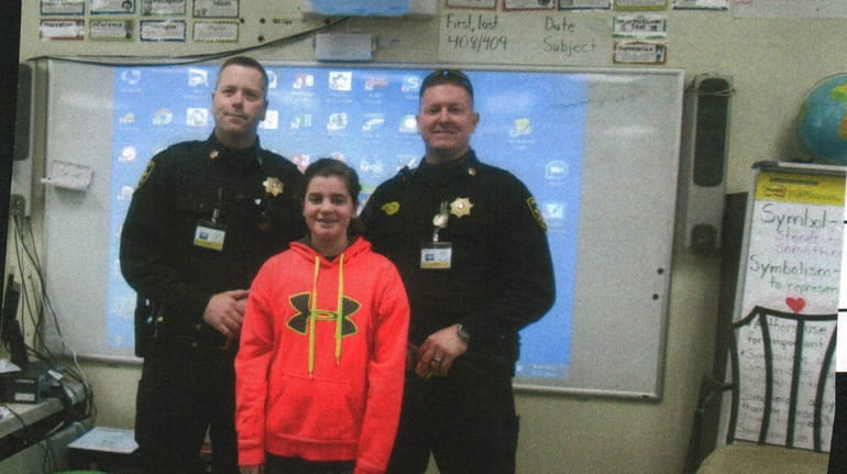 Kidsday reporter Ella Parkinson with deputy sheriffs Brian Butler and...