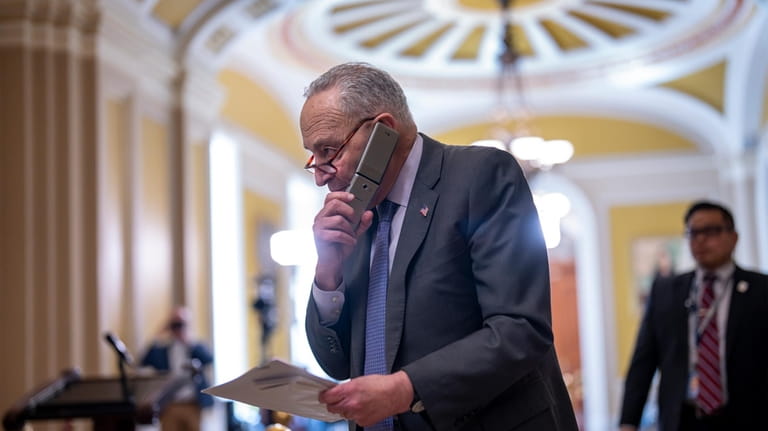 Senate Majority Leader Chuck Schumer, D-N.Y., talks on his phone...
