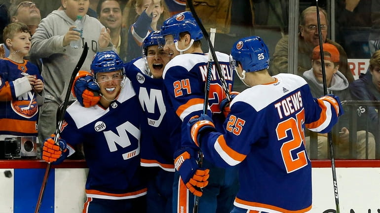 Mathew Barzal #13 of the New York Islanders celebrates his...