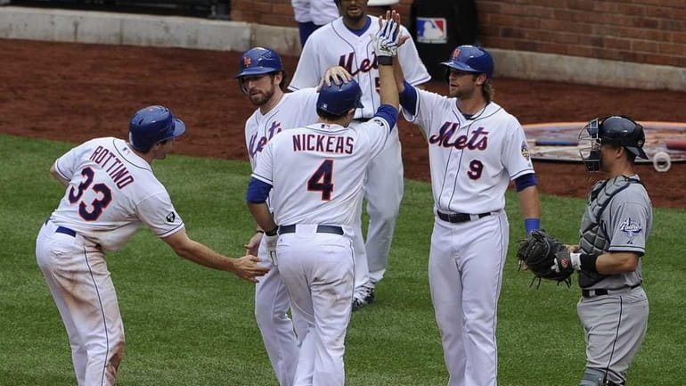 New York Mets catcher Mike Nickeas is met at home...