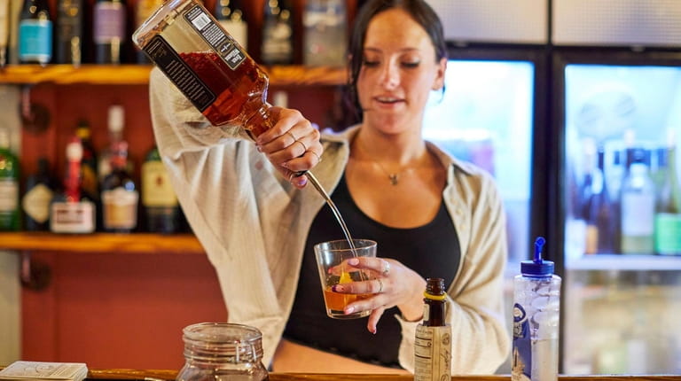 Kyra Walls makes an old fashioned at The Whiskey Barrel in Port...