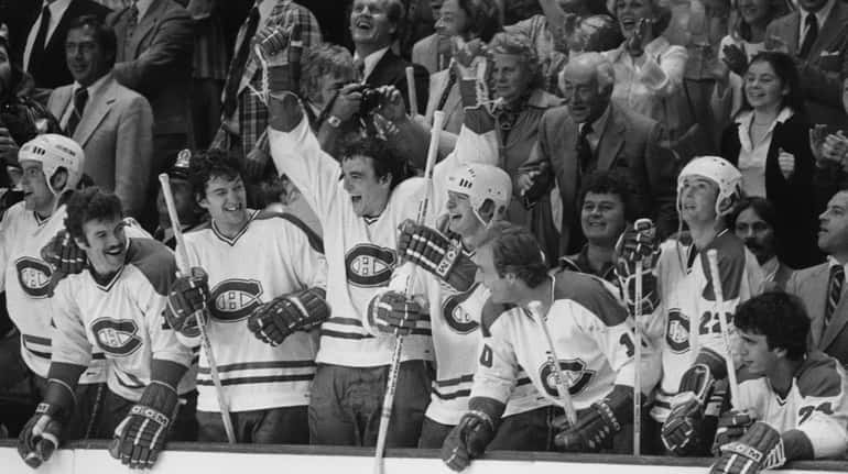 Players of the Montreal Canadiens on the bench jubilate as...