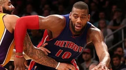 Greg Monroe of the Detroit Pistons drives against Carlos Booze...
