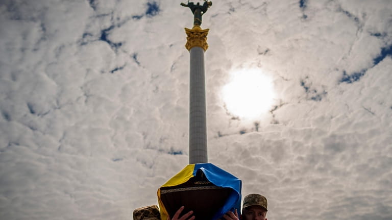 Ukrainian servicemen carry the coffin of their fallen fellow Vadym...