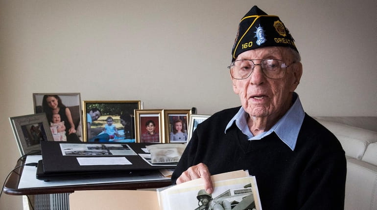 Iwo Jima survivor Phil Kahn with a photo of himself...