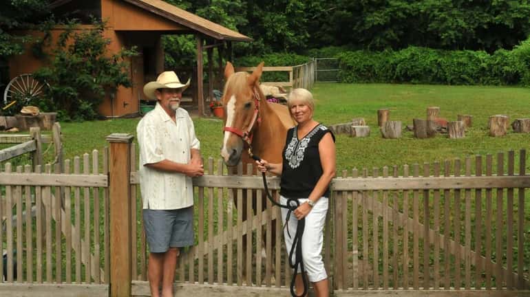 Tom and Maureen McKenna, with their horse “Danke Schoen,” outside...