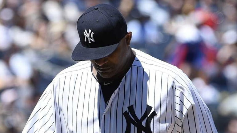 New York Yankees starting pitcher CC Sabathia walks to the...