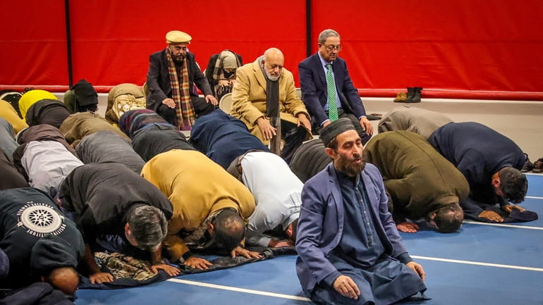 Members of Suffolk’s Muslim community pray Tuesday night in Brentwood...