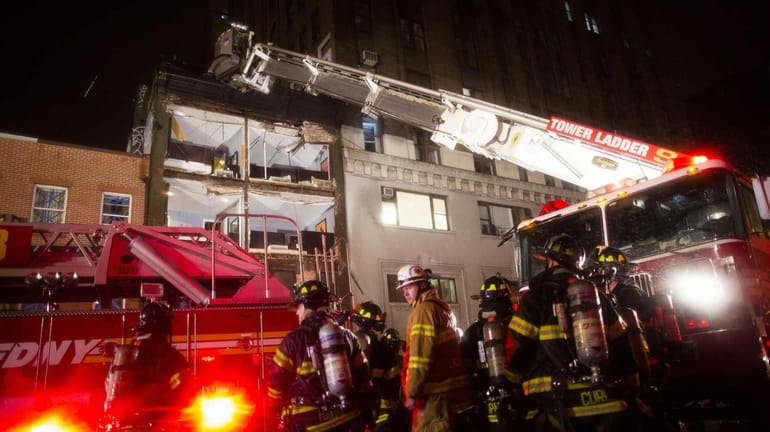 FDNY firefighters respond to the collapsed facade of a four-story...