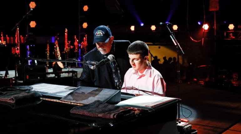 Billy Joel and 14-year-old Logan Riman play "Piano Man" together...