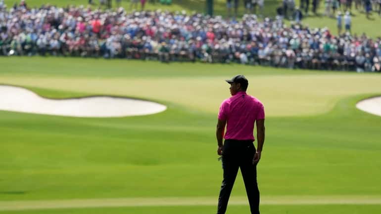 Tiger Woods waits to play on the second fairway during...