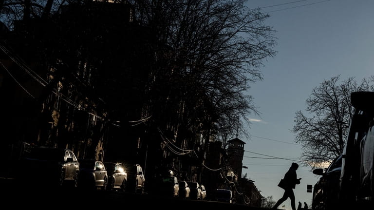 A woman walks on a street in downtown Kyiv, Ukraine,...