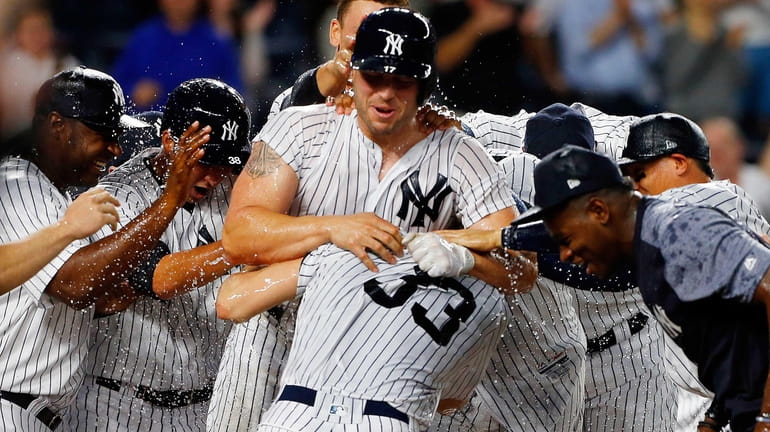 Matt Holliday #17 of the New York Yankees celebrates his...