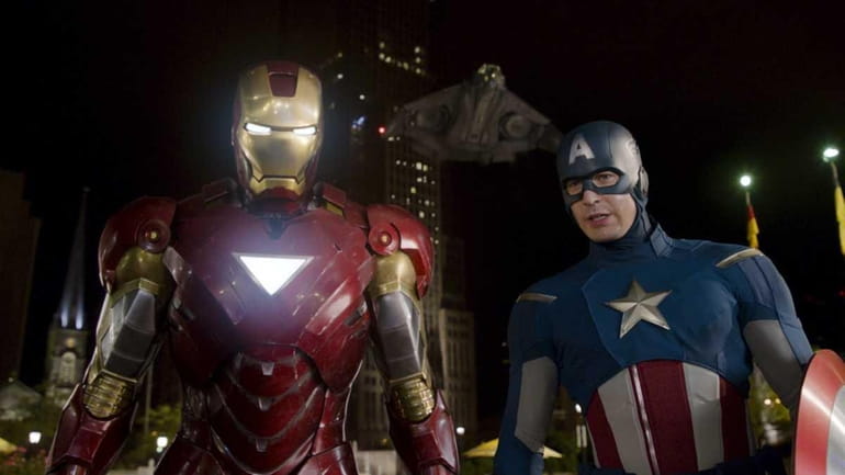Iron Man, portrayed by Robert Downey Jr., left, and Captain...