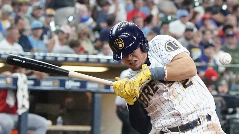 Milwaukee Brewers' Luis Uria is hit by a pitch during...