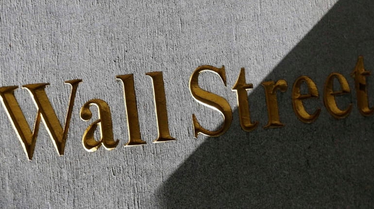 A Wall Street sign on the side of a building...