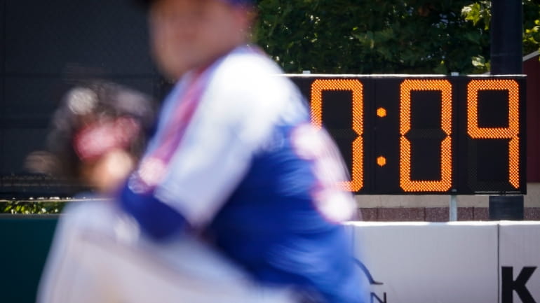 A pitch clock is deployed to restrict pitcher preparation times...
