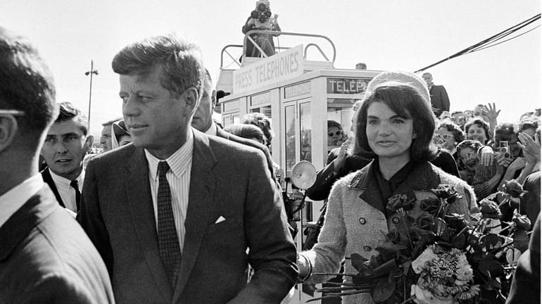 President John F. Kennedy and his wife Jacqueline Kennedy are...