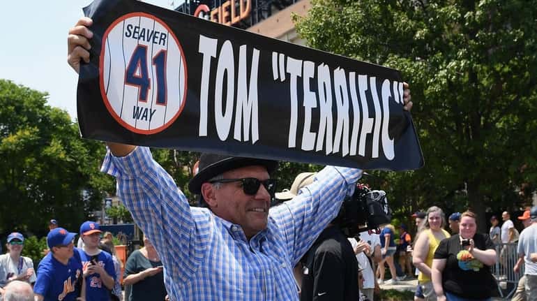 A fan holds a sign for Tom Seaver during the...