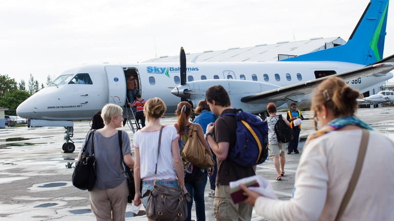 Passengers and tourists boarding a flight in Nassau, Bahamas. 