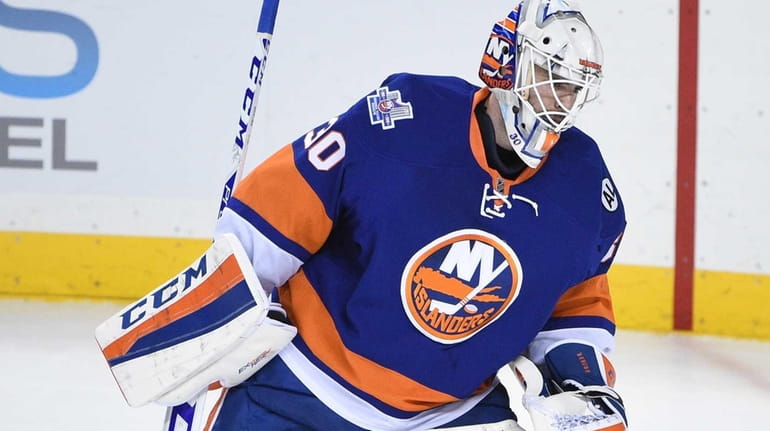New York Islanders goalie Jean-Francois Berube skates back to the...