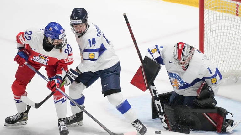 Finland goaltender Sanni Ahola (1) makes a save against Czechia's...