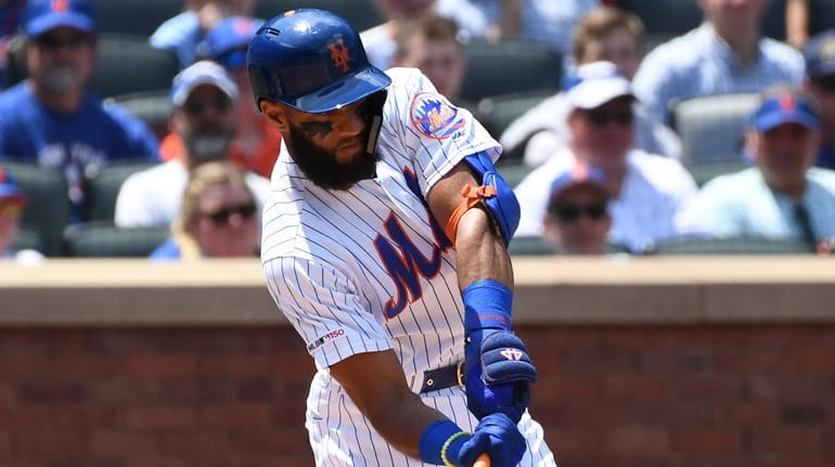 New York Mets shortstop Amed Rosario hits an RBI single...