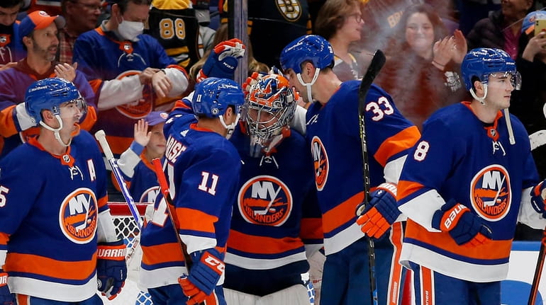Semyon Varlamov #40 of the Islanders celebrates with his teammates...