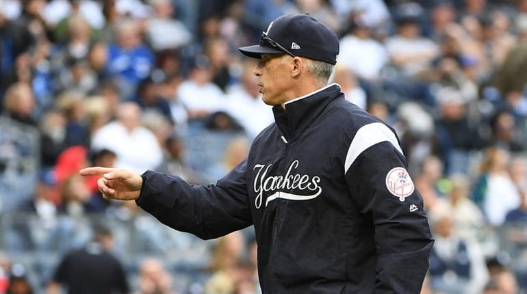 New York Yankees manager Joe Girardi walks to the dugout...