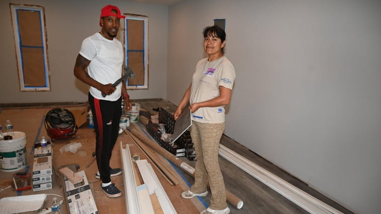 Toyé Lane and business partner Fanny Pina work on a house...