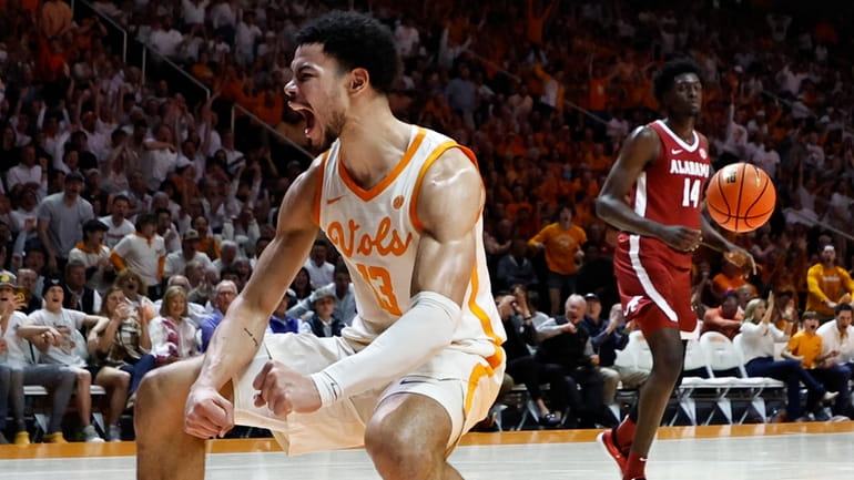 Tennessee forward Olivier Nkamhoua (13) reacts to dunking the ball...