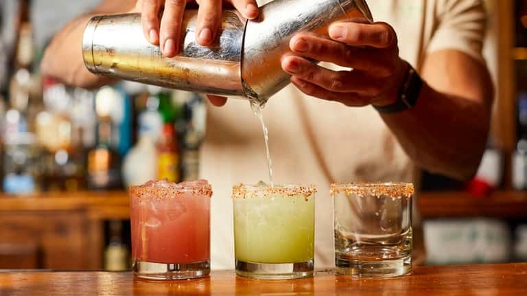 Bartender Andy Campos makes spicy pepper margaritas at Verde Kitchen...