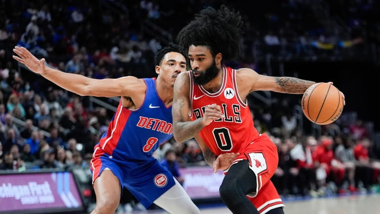 Chicago Bulls guard Coby White (0) drives on Detroit Pistons...