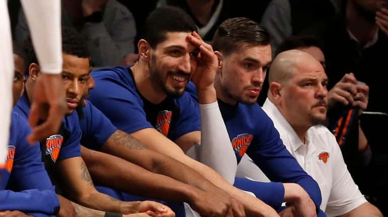 Enes Kanter of the Knicks looks on from the bench...