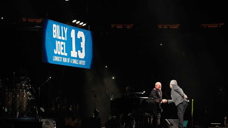 Billy Joel, left, takes the stage at Madison Square Garden...