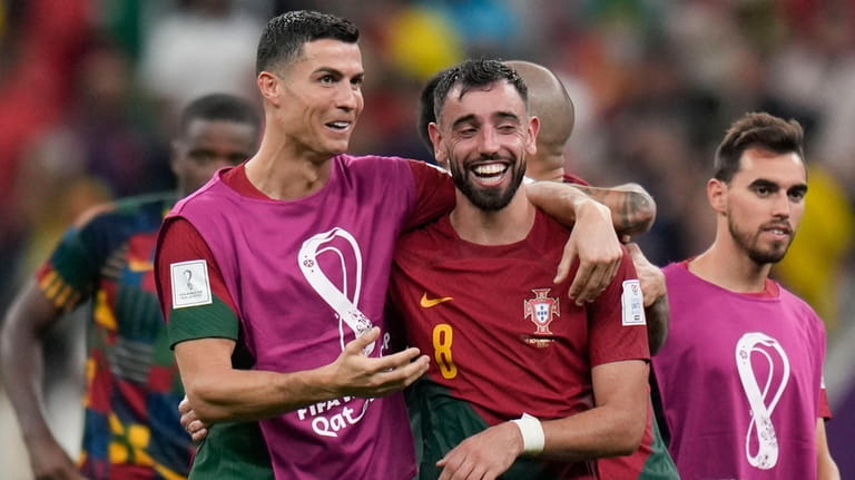 Portugal's Cristiano Ronaldo and Portugal's Bruno Fernandes celebrate their win...