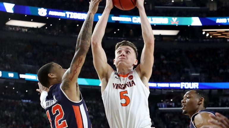 Kyle Guy, shown here driving to the basket in the...