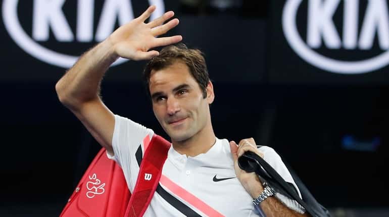 Roger Federer waves to the crowd after winning his semifinal...